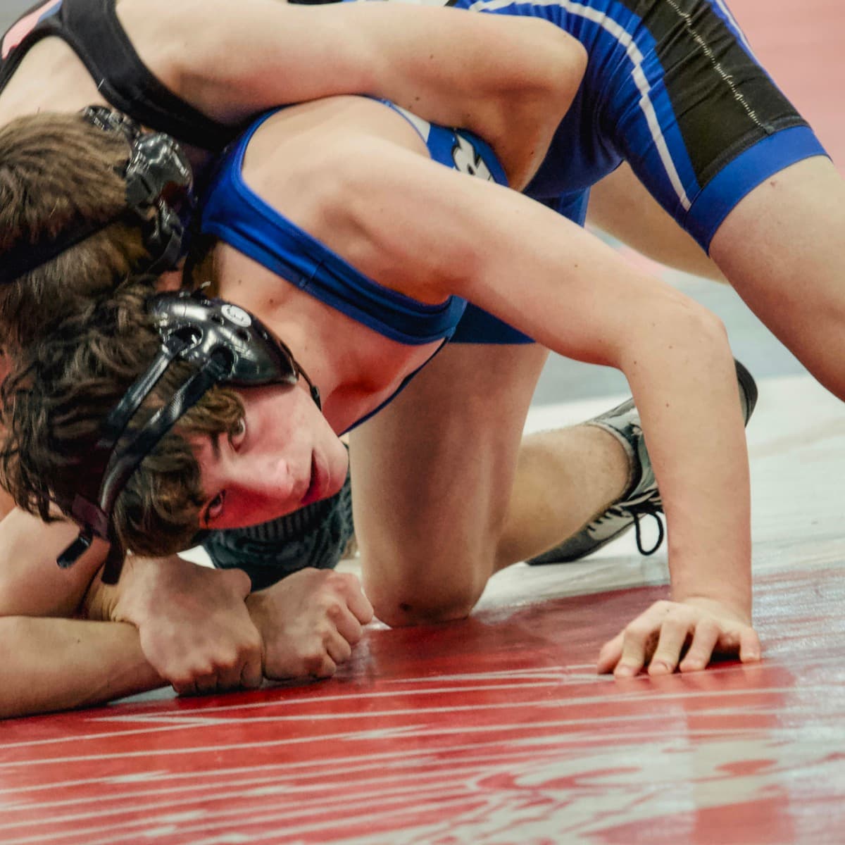 High school wrestler riding his opponent in the top position